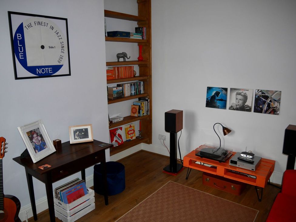 A living room with a stereo system and vinyl records at Anchor Cottage in Cleethorpes