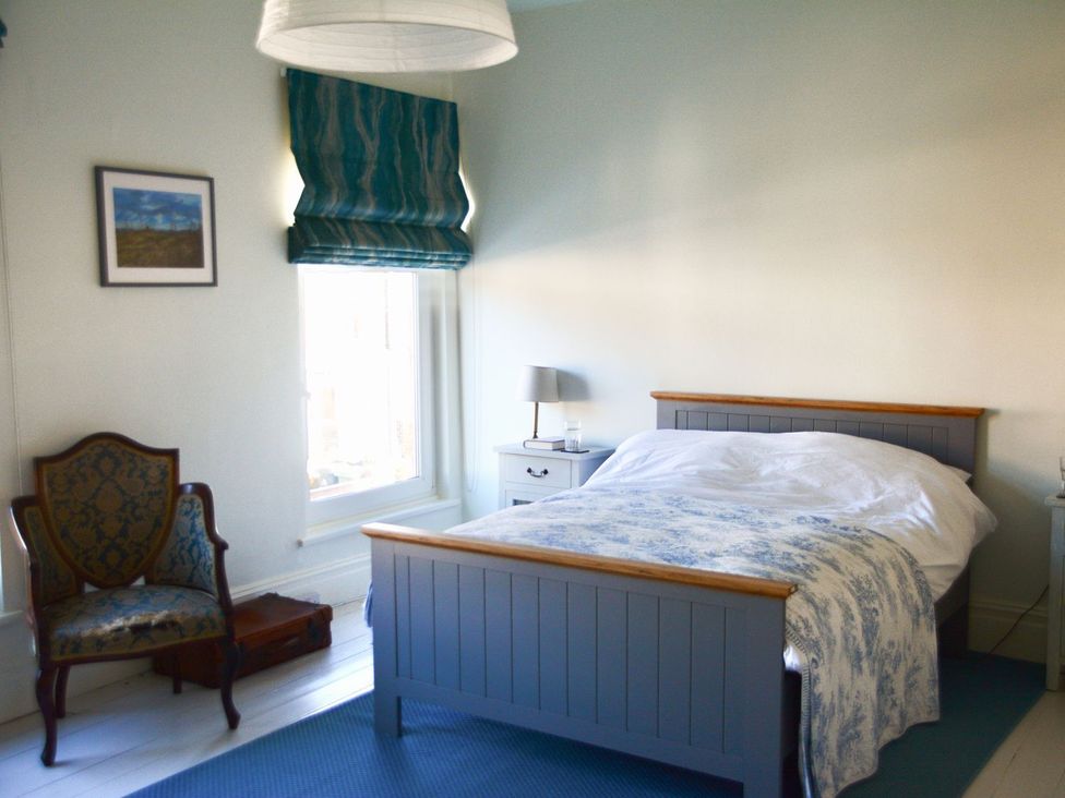 A bedroom with a bed and nightstand at Anchor Cottage in Cleethorpes
