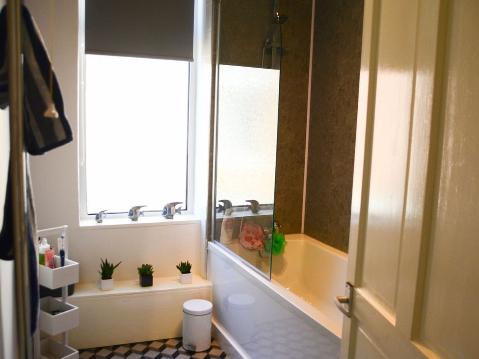 A bathroom with a bathtub and shower at Anchor Cottage in Cleethorpes