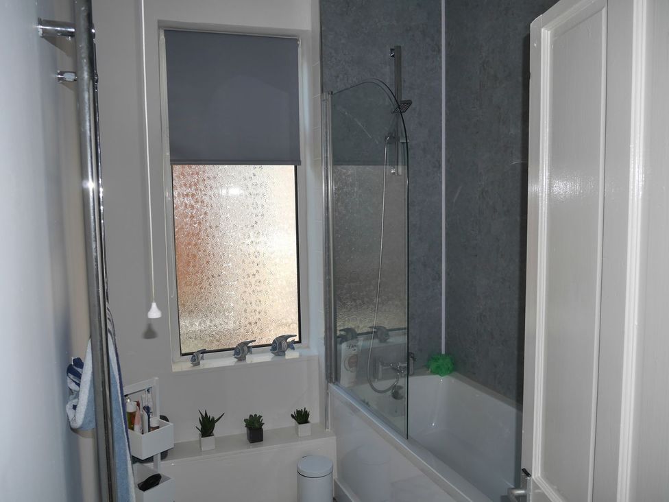 A bathroom with a bathtub and shower at Anchor Cottage in Cleethorpes
