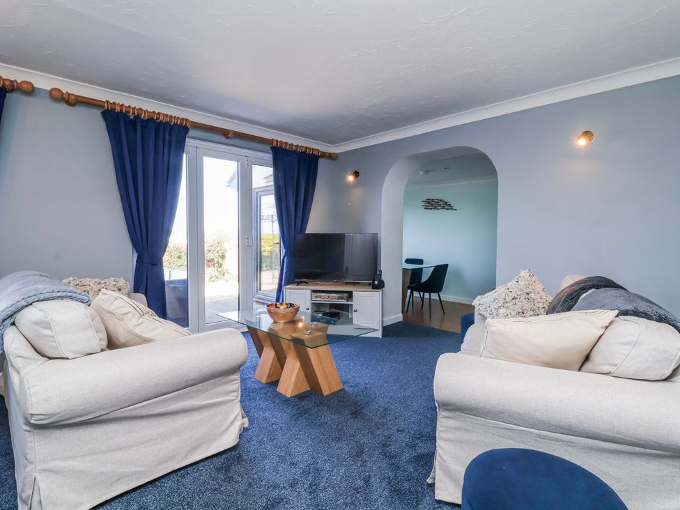 A living room with a sofa and television at Sea Spray in Westward Ho!