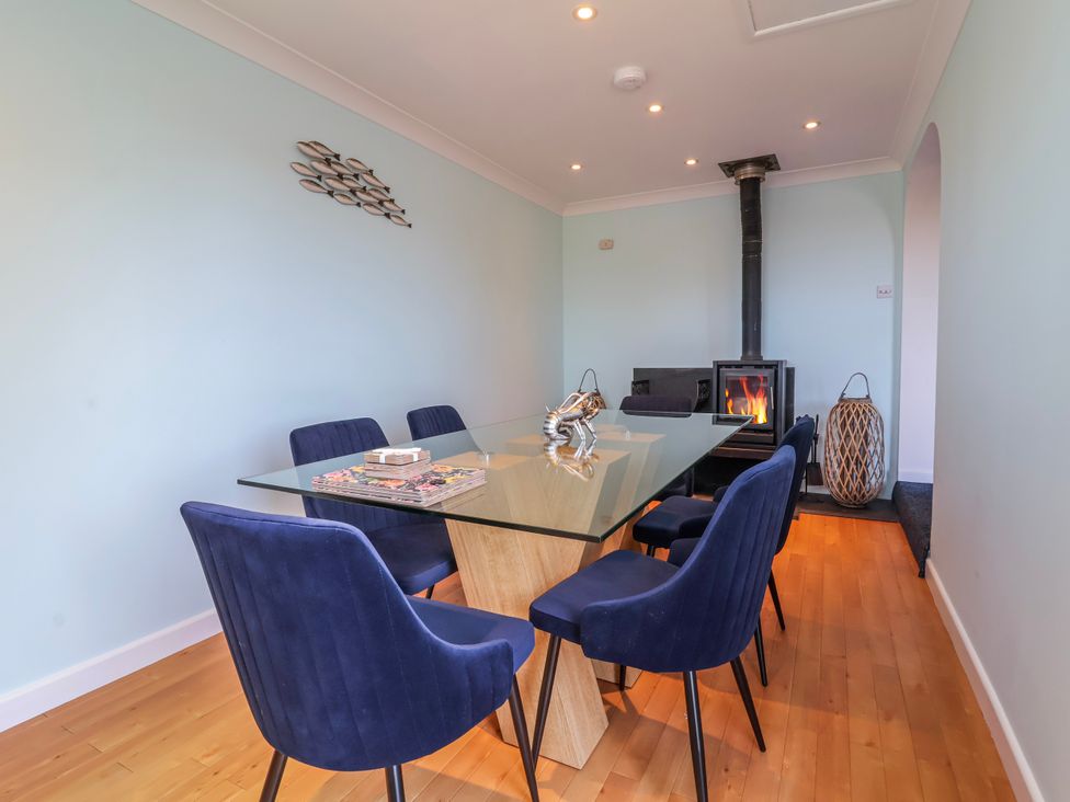 A dining room with a glass table and chairs at Sea Spray, Westward Ho!