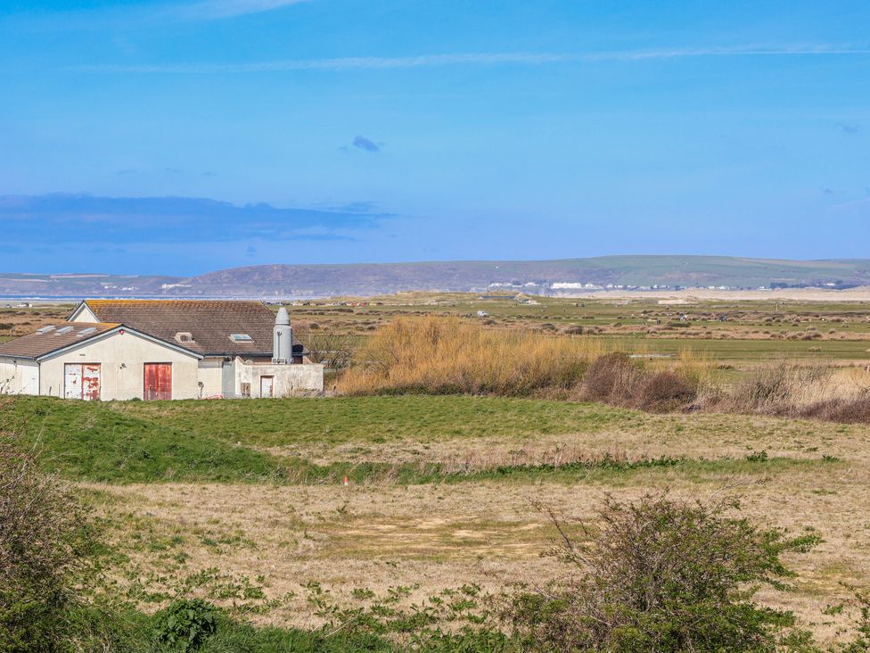 A house in a field with hills in the background at Sea Spray, Westward Ho!