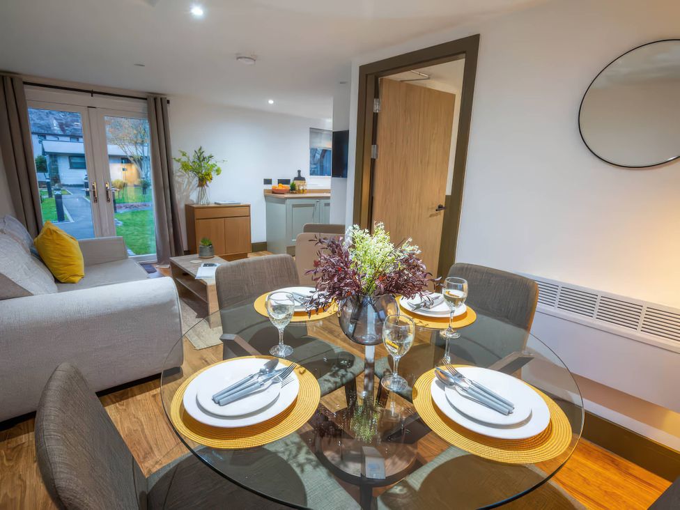 A dining area with a table set for meals at Fir Cottages in Llanrwst