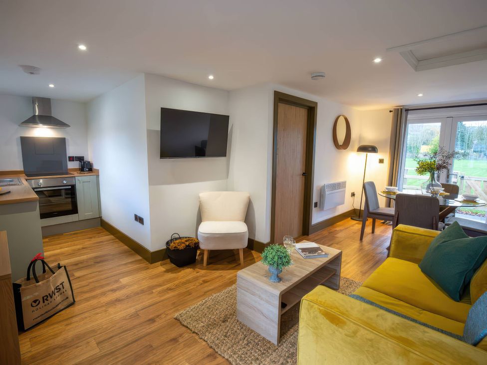 A living room with a sofa and coffee table at Silver Birch Cottage in Llanrwst