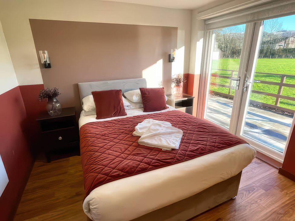 A bedroom with a bed and bedside table at River View Cottage Llanrwst