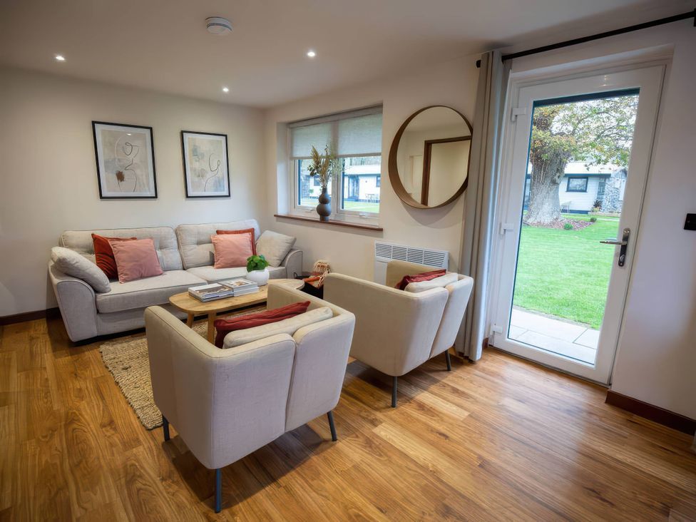 A living room with a sofa and armchairs at Mountain View Cottage in Llanrwst