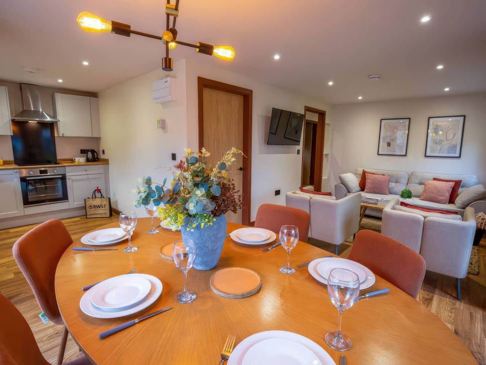 A dining room with a table set for meals at Mountain View Cottage in Llanrwst