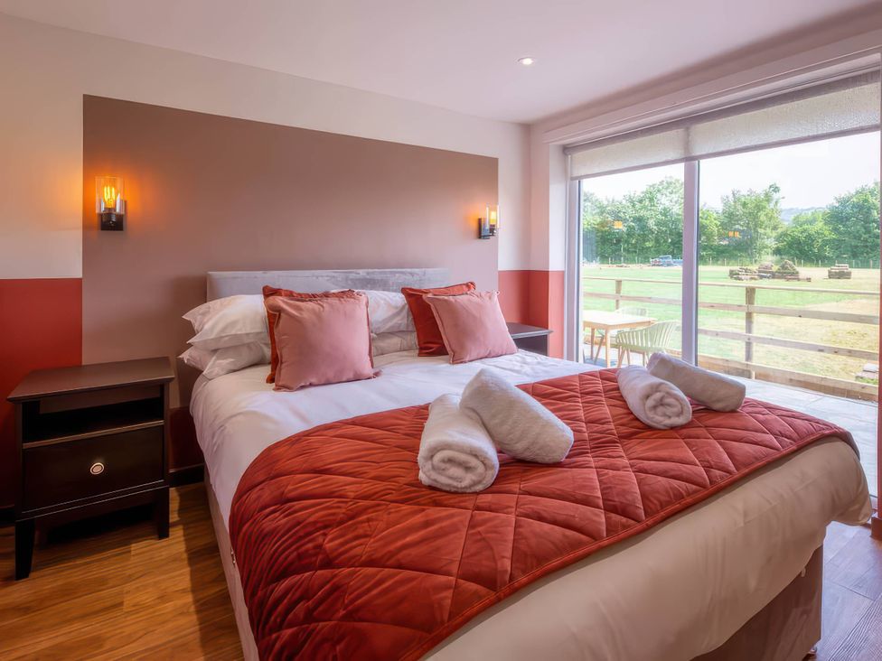 A bedroom with a bed and window at Mountain View Cottage in Llanrwst