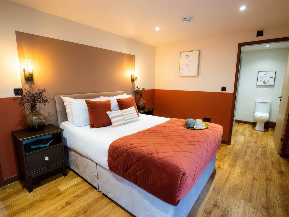 A bedroom with a bed and nightstand at Mountain View Cottage in Llanrwst