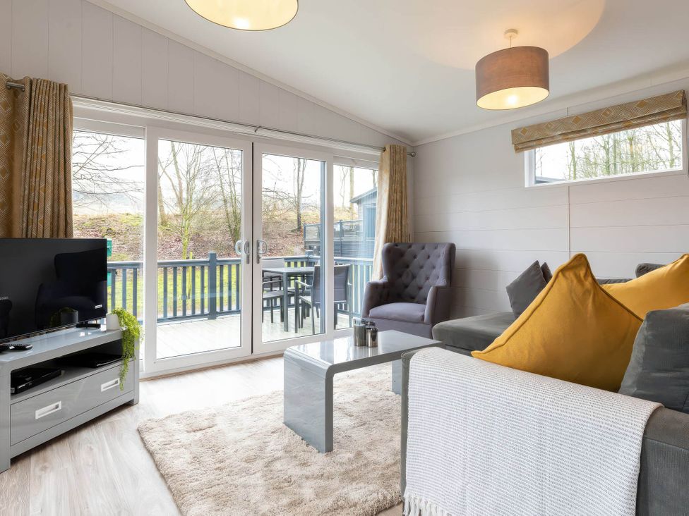 A living room with furniture and windows at The Falls in Leyburn