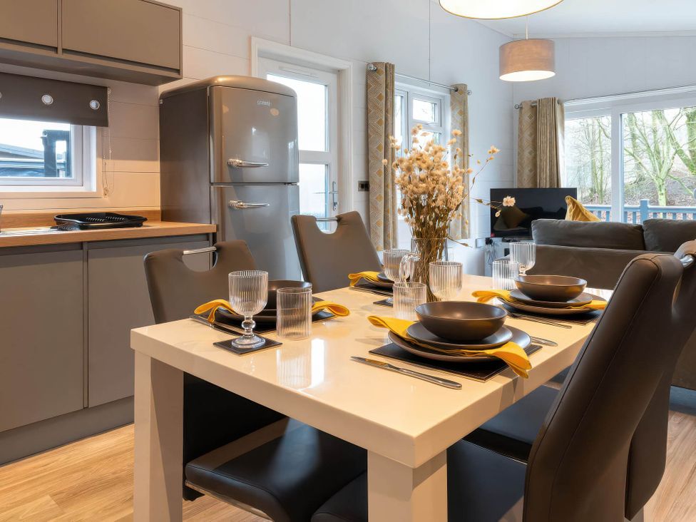 A dining room with a table set for meals at The Falls in Leyburn