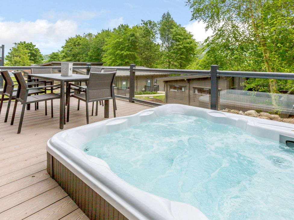 A hot tub with a table and chairs on a deck at Wensleydale (Pet) Aysgarth