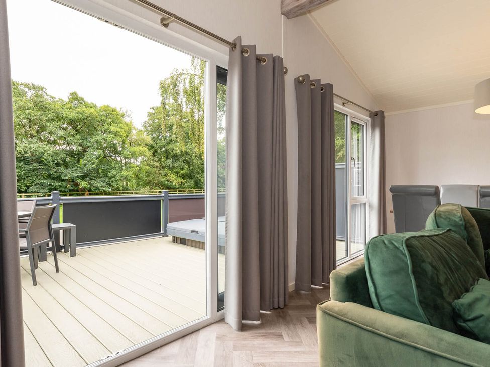 A living room with a balcony and outdoor furniture at Wensleydale (Pet) Aysgarth