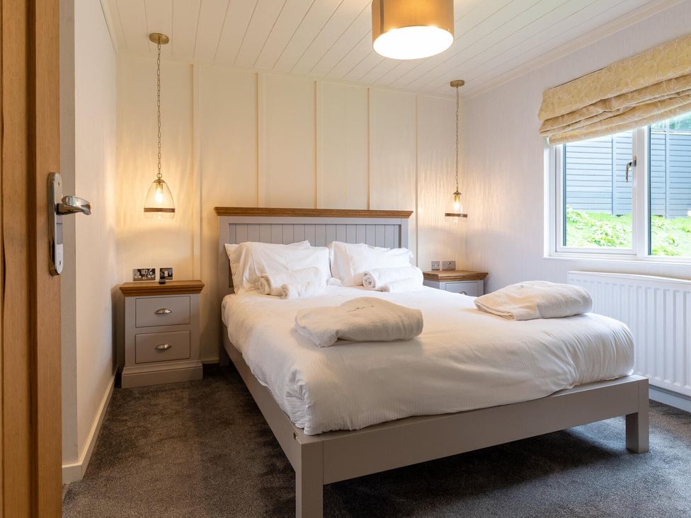 A bedroom with a bed and nightstand at Wensleydale (Pet) Aysgarth