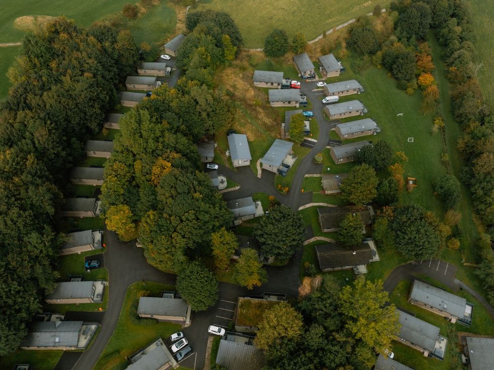 An aerial view of cabins and trees at Wensleydale (Pet) Aysgarth