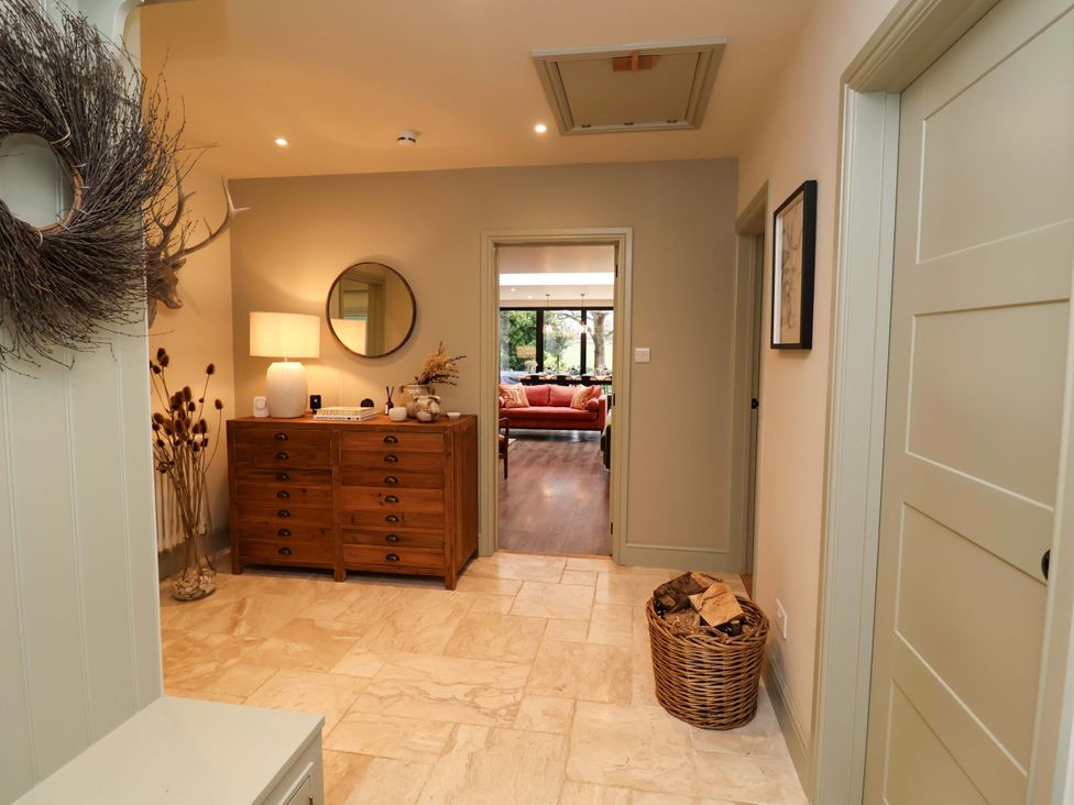 A hallway with a console table and a mirror at Fairview in Darsham