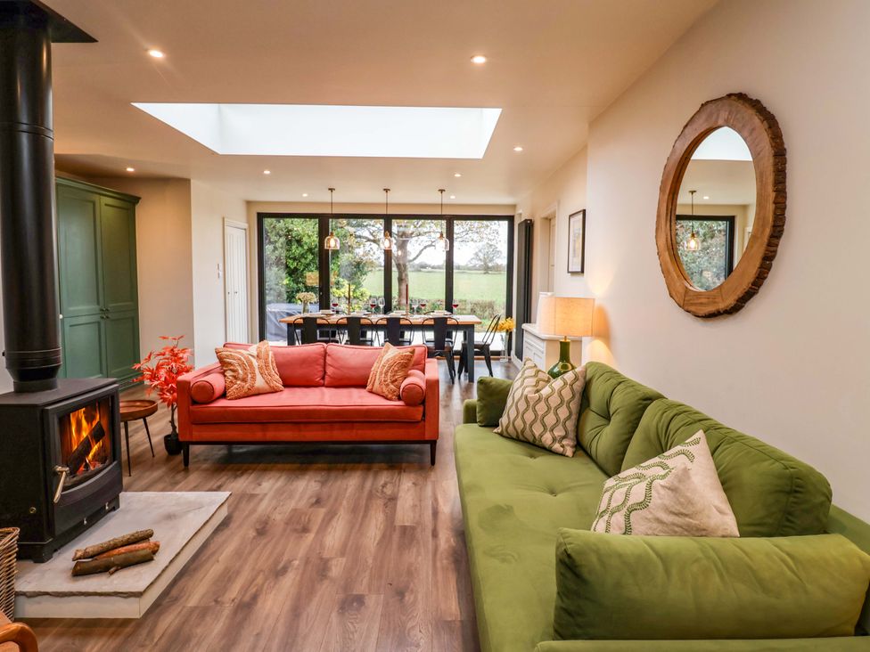 A living room with sofas and a dining area at Fairview in Darsham