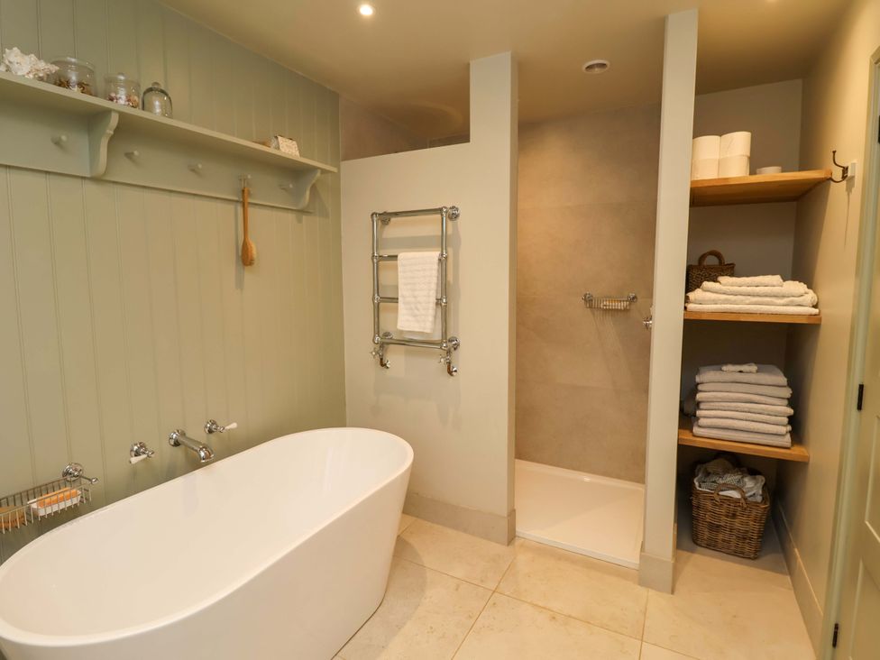 A bathroom with a bathtub and shower area at Fairview in Darsham
