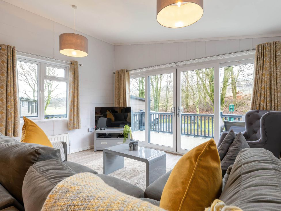 A living room with a sofa and television at The Falls (Pet) Leyburn