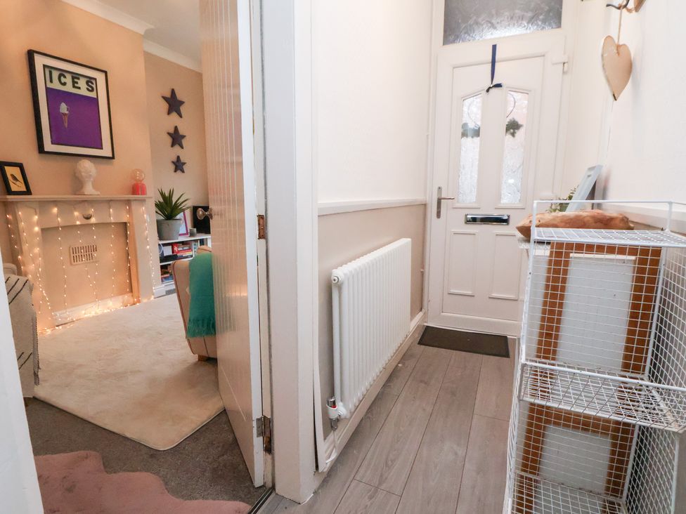 A hallway with a door and a radiator at 50 Gladstone Avenue Chester