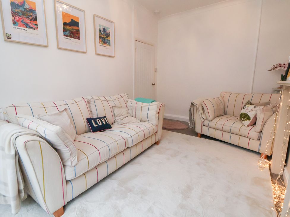 A living room with two sofas and wall art at 50 Gladstone Avenue Chester