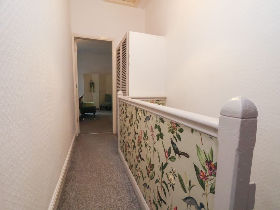 A hallway with a railing and door at 50 Gladstone Avenue, Chester