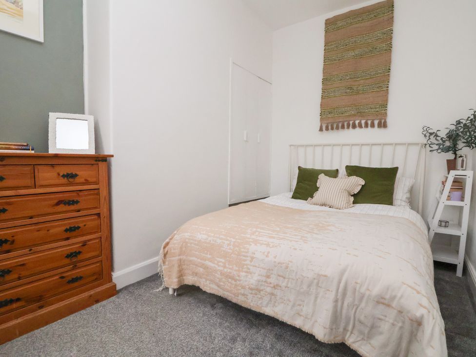 A bedroom with a bed, drawer, and wall hanging at 50 Gladstone Avenue Chester