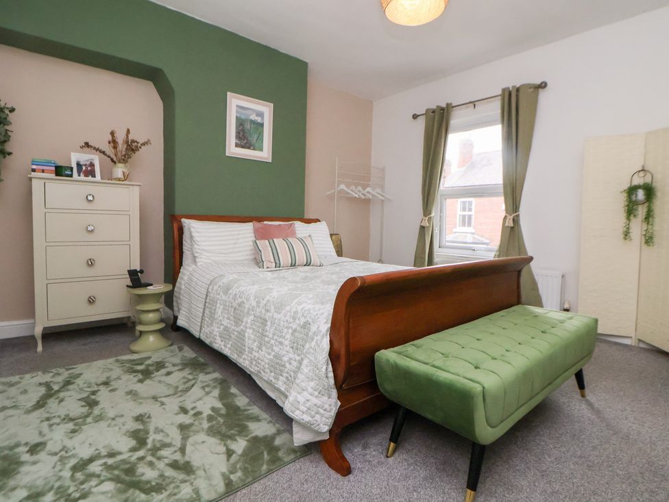 A bedroom with a bed and dresser at 50 Gladstone Avenue, Chester