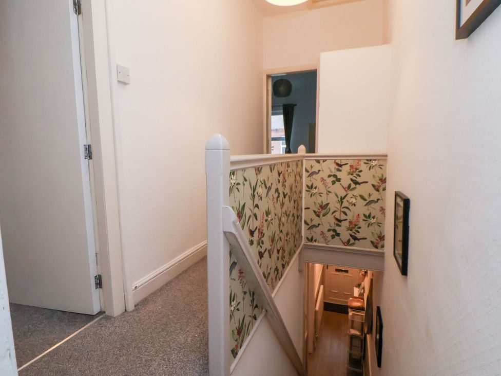 A hallway with a staircase and decorative wall at 50 Gladstone Avenue Chester