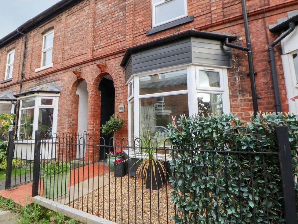 An outdoor view of a brick house with a garden and pathway at 50 Gladstone Avenue Chester