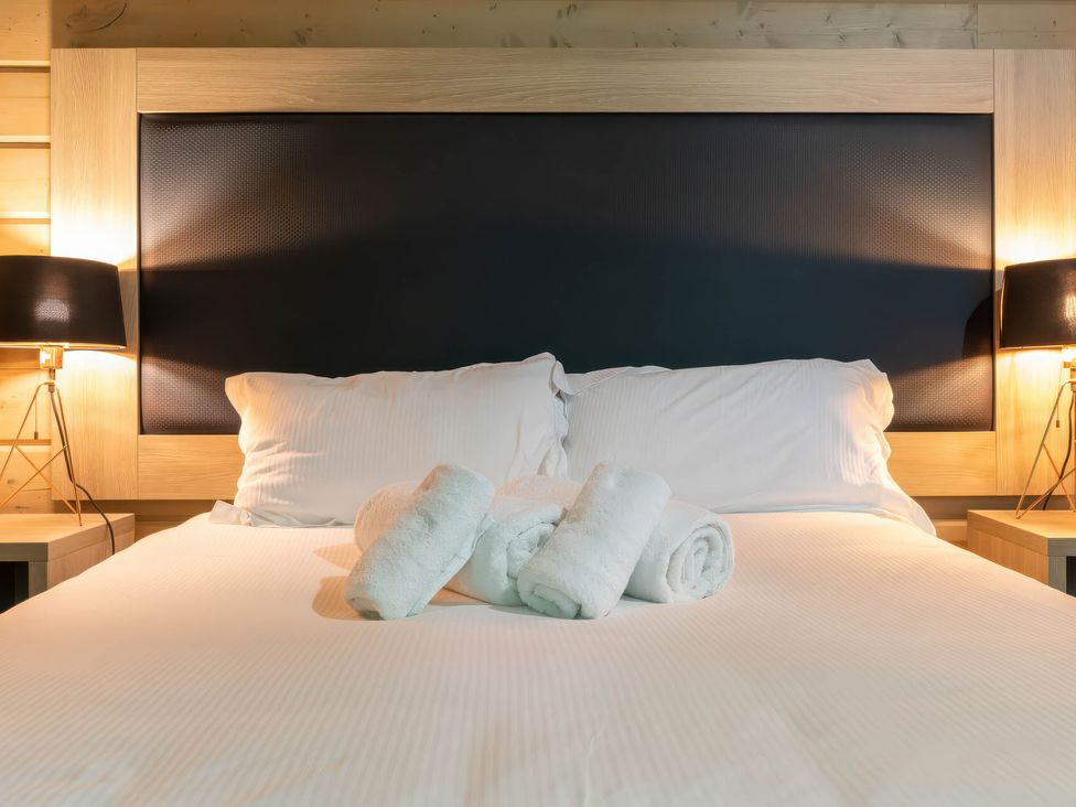 A bedroom with a bed and towels at Middleham Leyburn