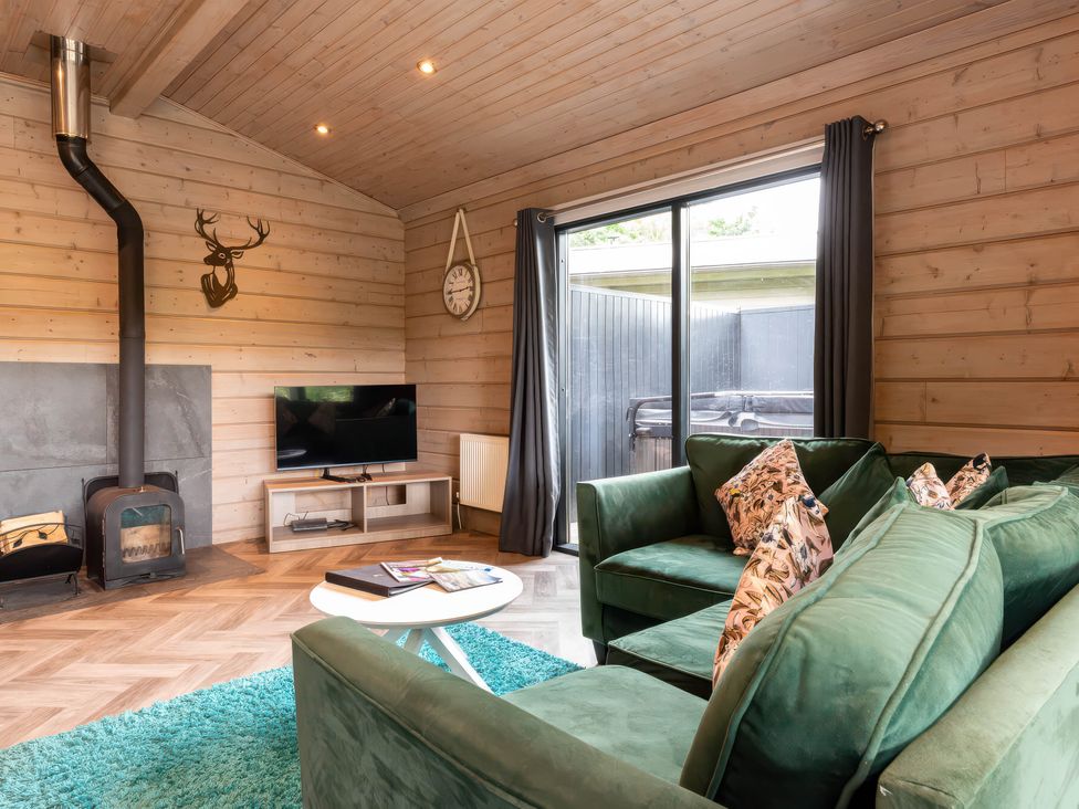 A living room with a sofa and fireplace at Middleham (Pet) Leyburn