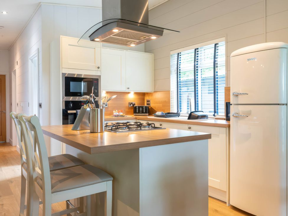 A kitchen with appliances and seating at Bainbridge in Leyburn