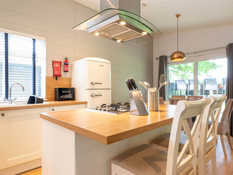 A kitchen with a refrigerator and stove at Bainbridge in Leyburn
