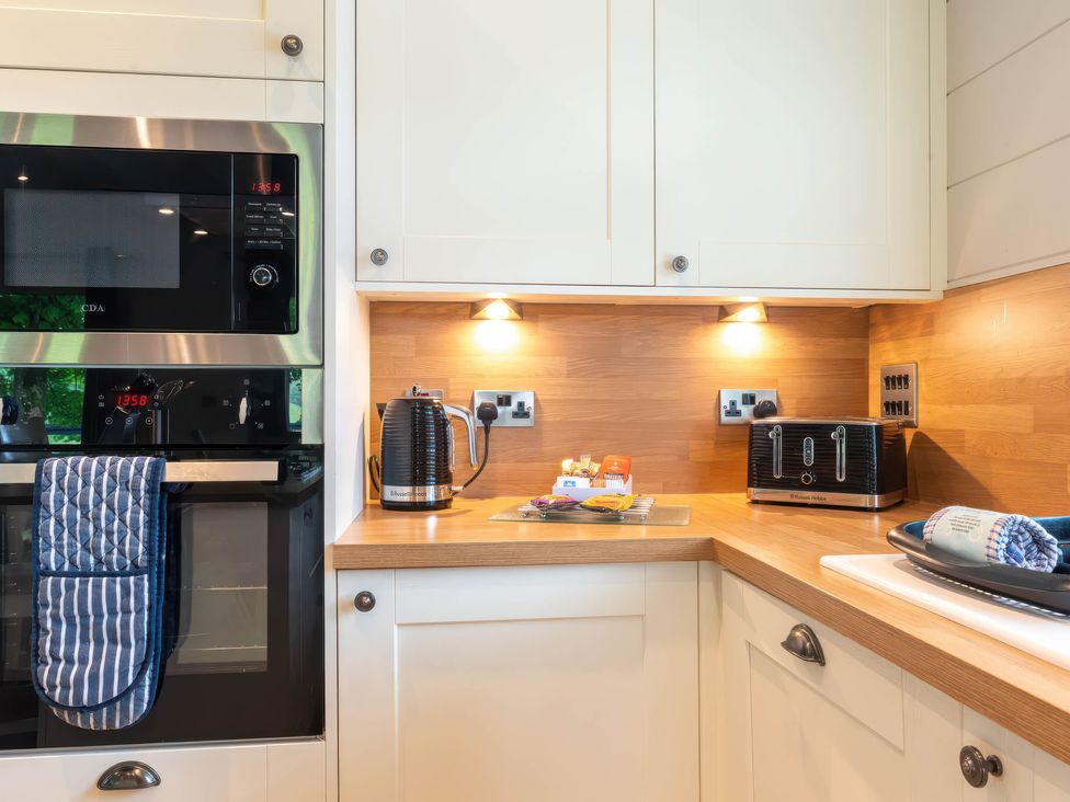 A kitchen with a microwave, oven, kettle, and toaster at Bainbridge in Leyburn