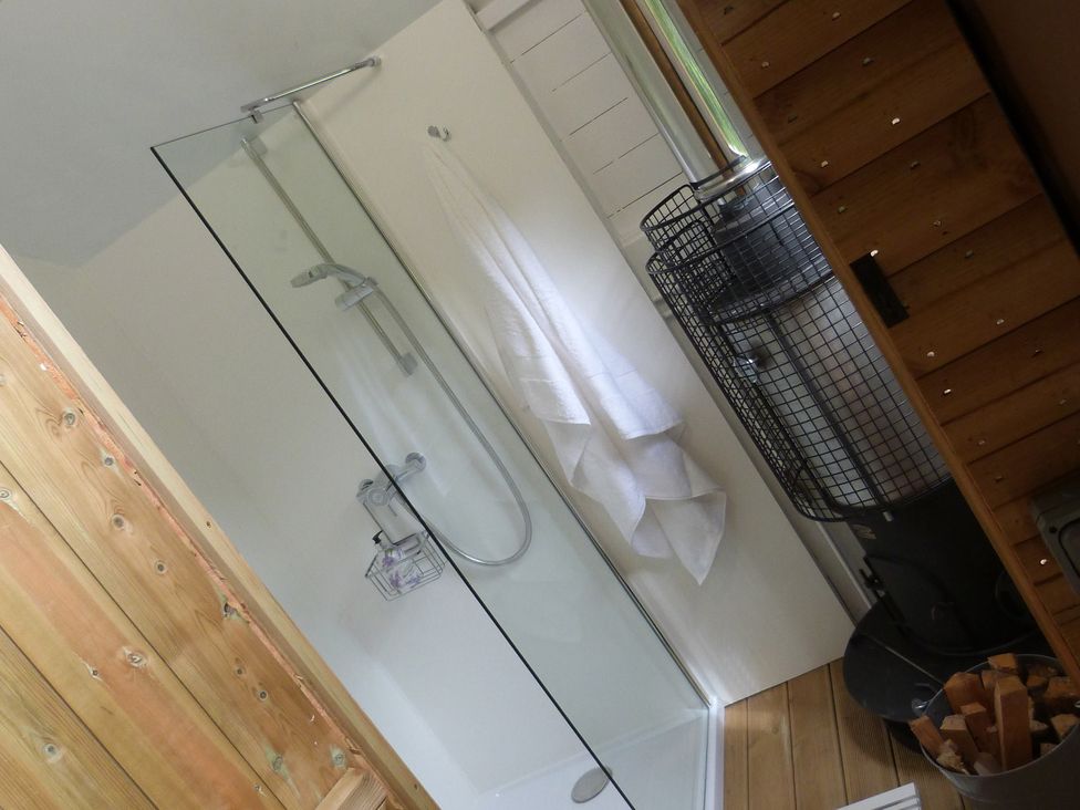 A bathroom with a shower and stove at Aeron in Newcastle Emlyn