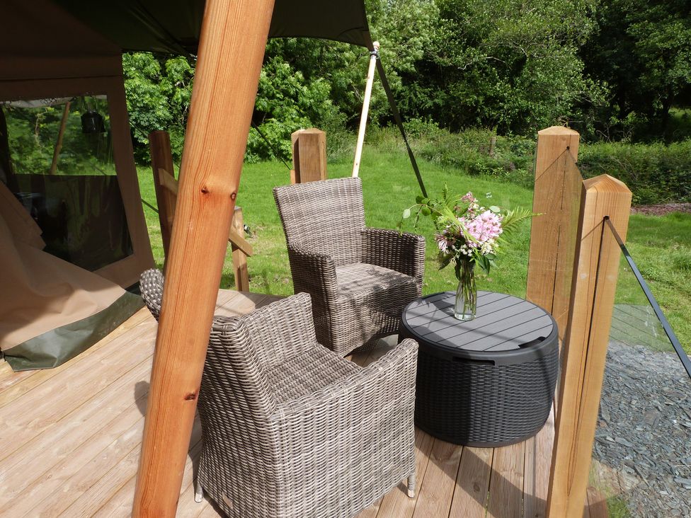 An outdoor seating area with two chairs and a table at Teifi Newcastle Emlyn
