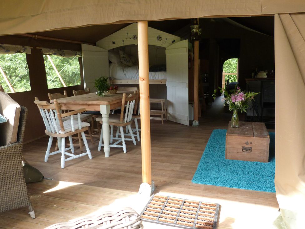 A living room with a dining table and chairs at Teifi Newcastle Emlyn