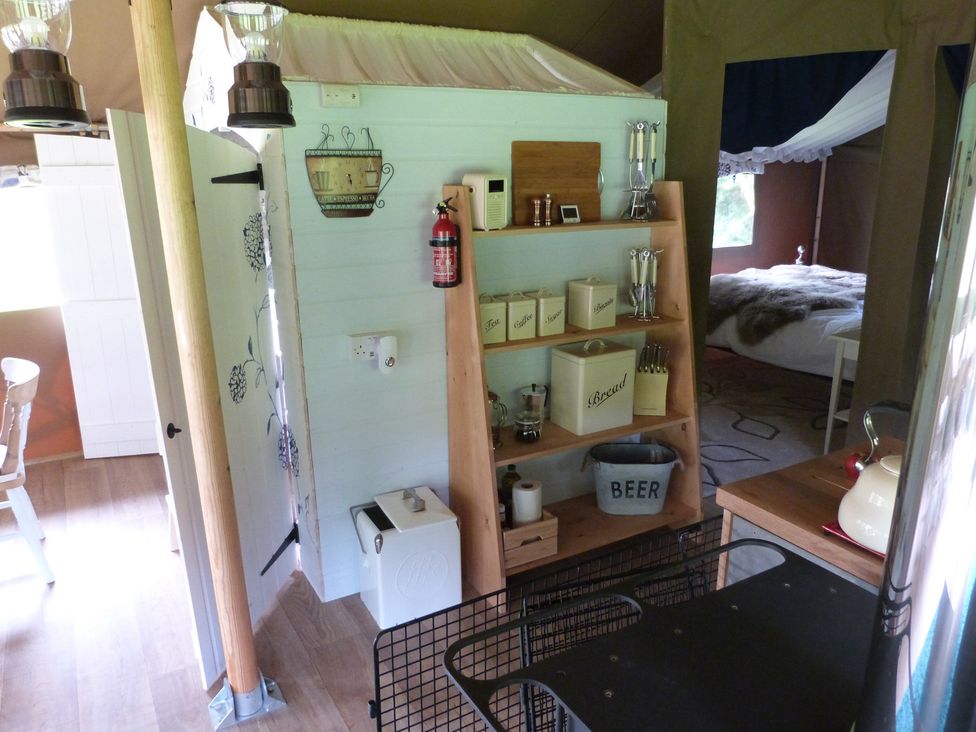 A kitchenette with shelving and utensils at Teifi in Newcastle Emlyn