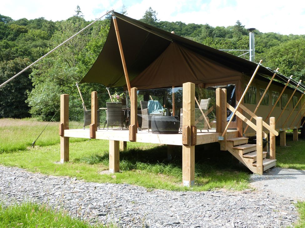 A tent with a deck area and furniture at Teifi in Newcastle Emlyn