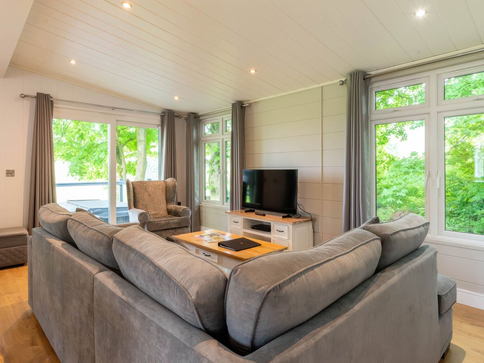 A living room with a sofa and a television at Bainbridge (Pet) Leyburn