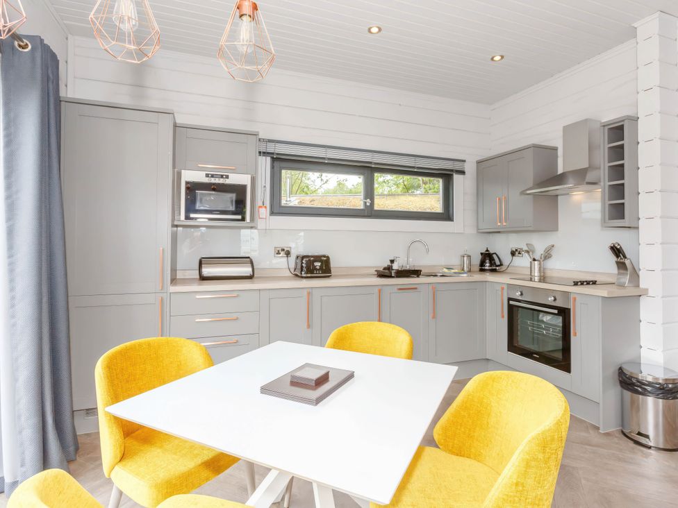 A kitchen with a table and chairs at Leyburn in Leyburn