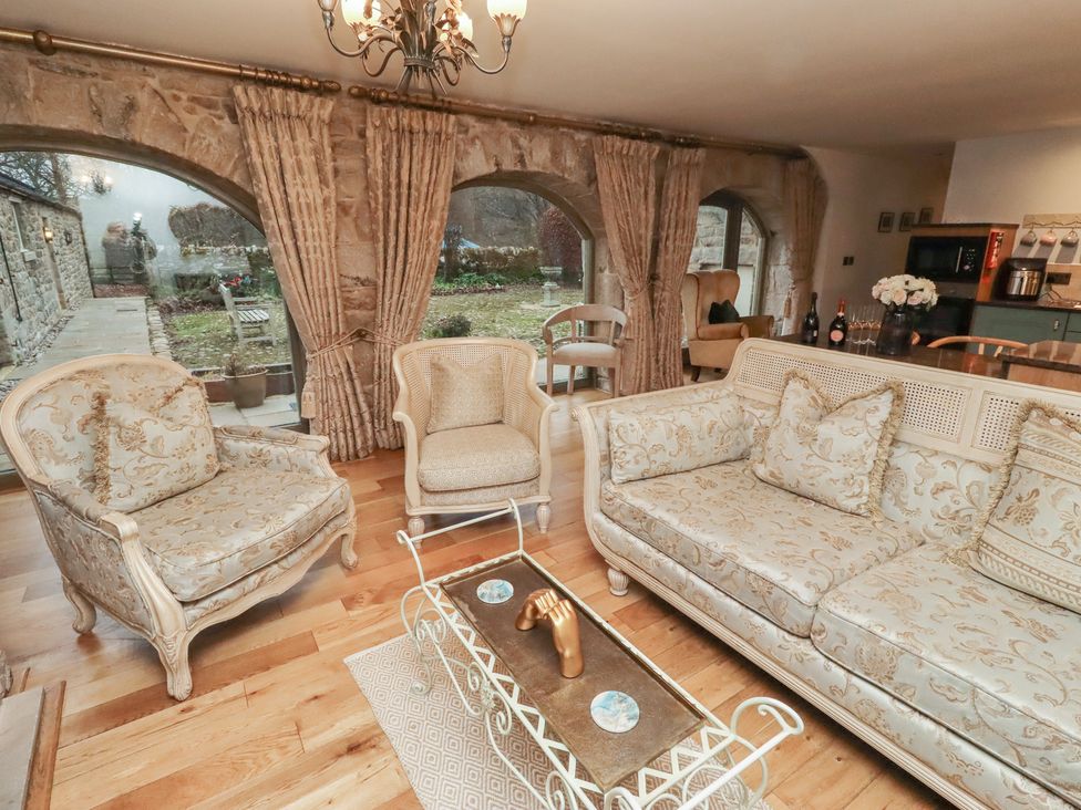 A living room with chairs and a sofa at The French in 