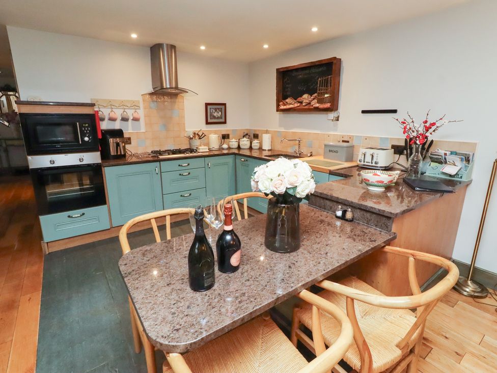 A kitchen with a table and chairs at The French in 