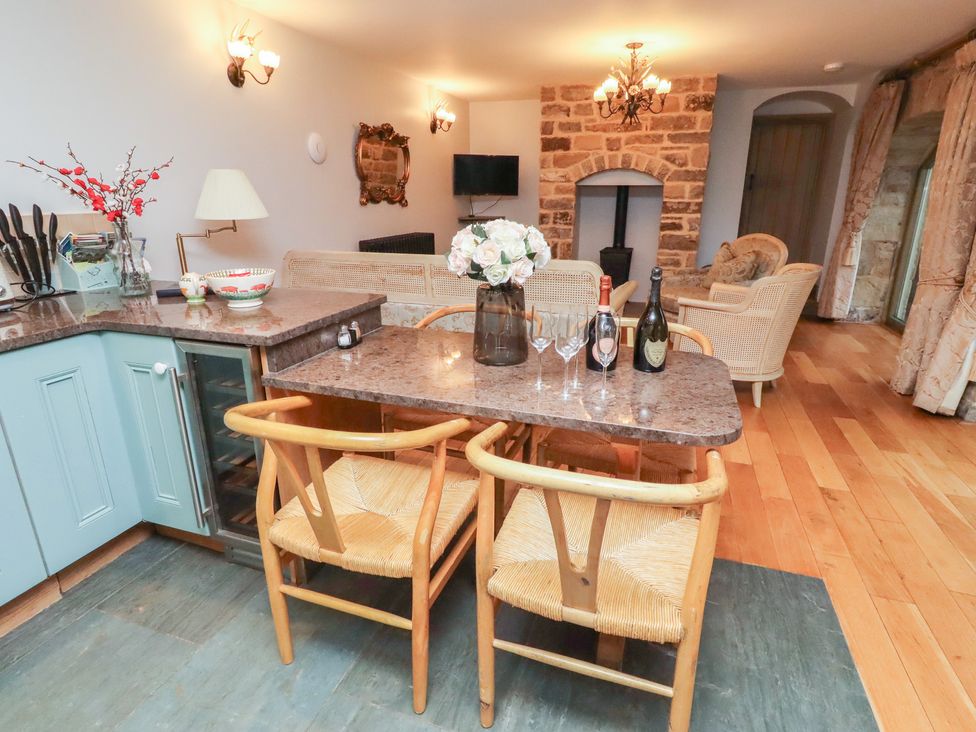 A kitchen with a dining table and chairs at The French