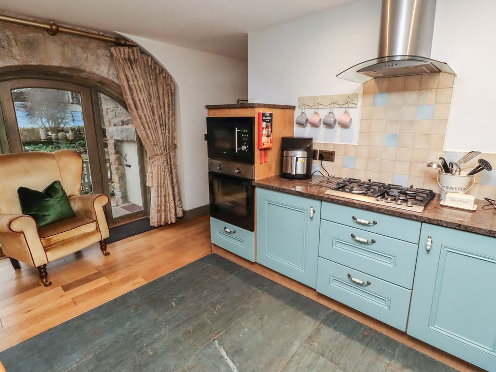 A kitchen with a stove and cabinets at The French