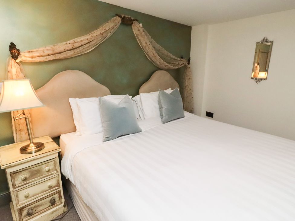 A bedroom with a bed and bedside table at The French