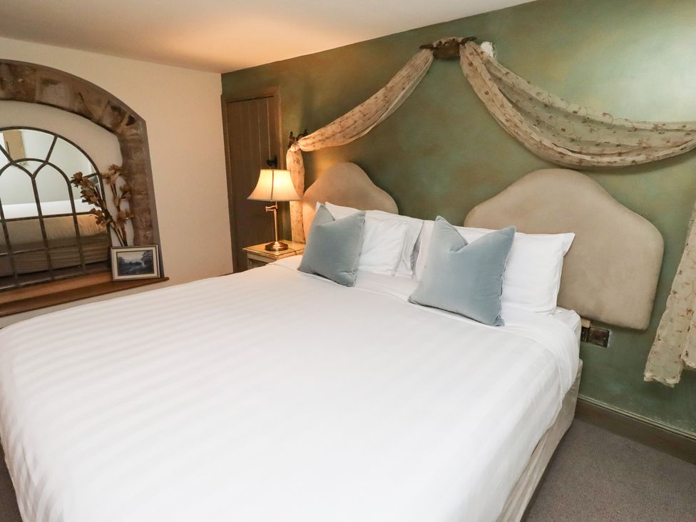 A bedroom with a bed and a lamp at The French 