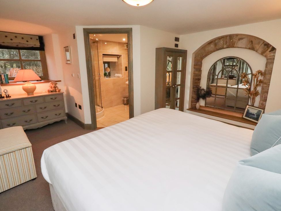 A bedroom with a bed and dresser at The French